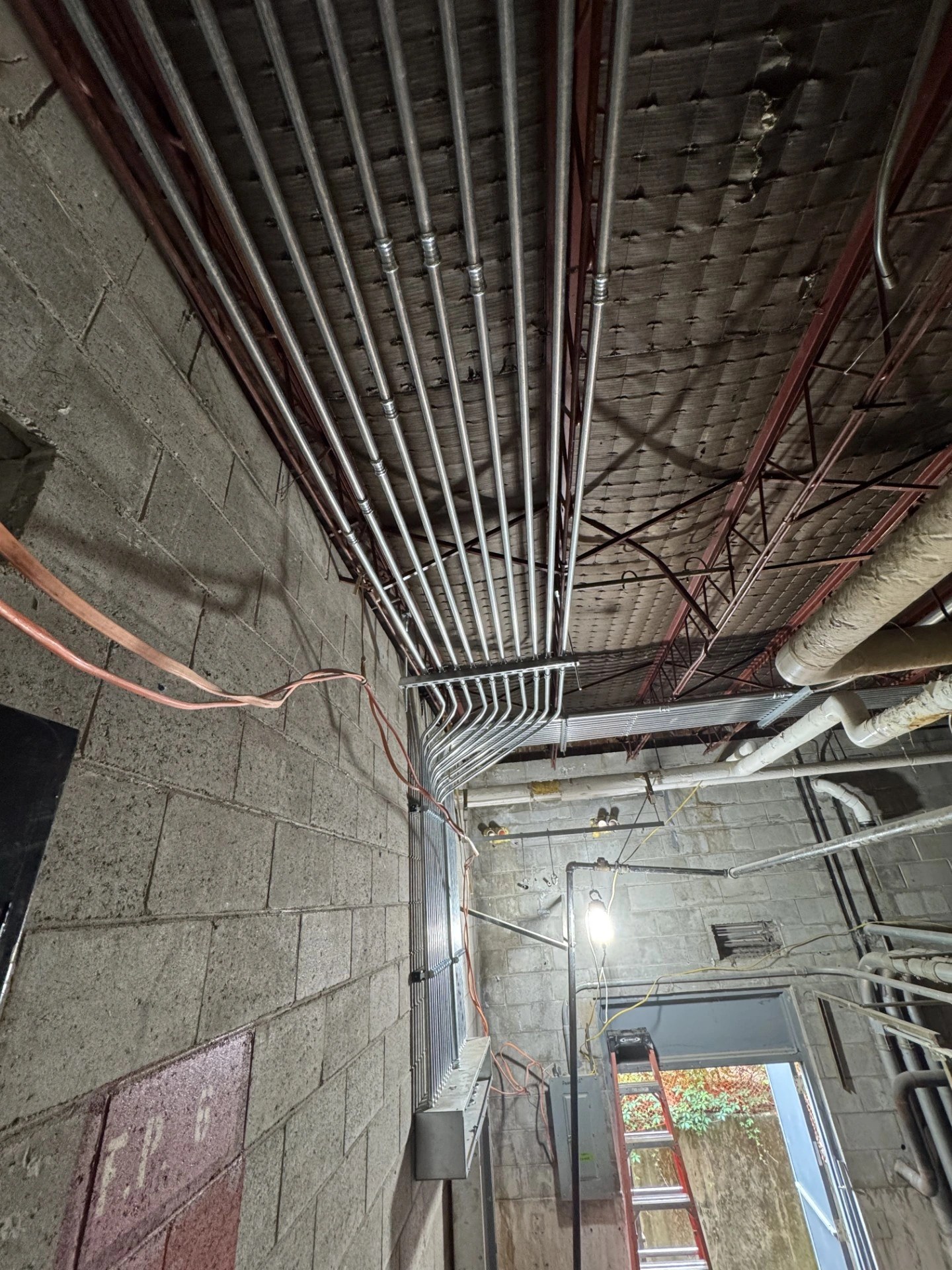 Overhead conduit rack installation at the Clemson Armory project