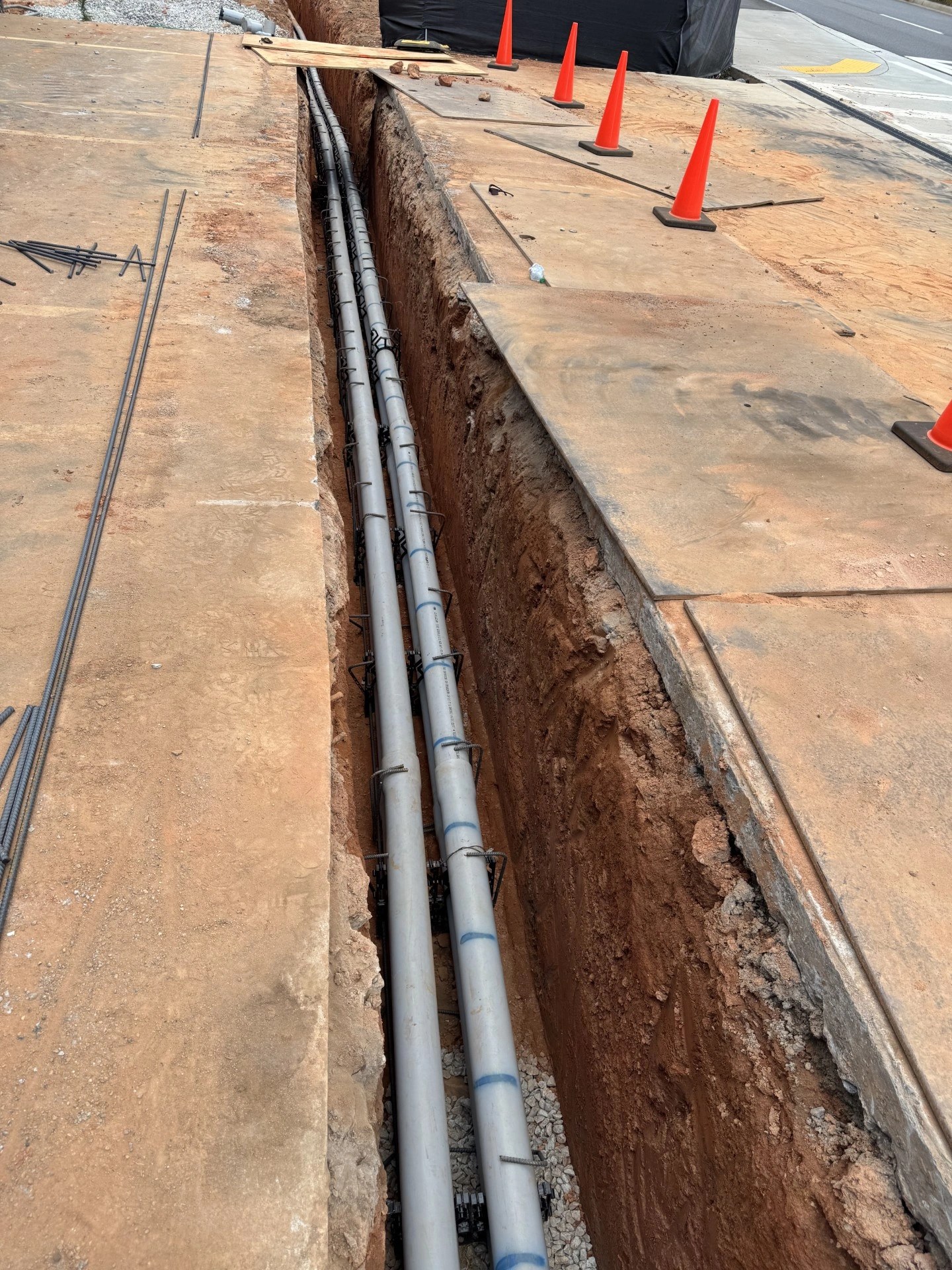 Underground conduit installation in trench at the Clemson Firehouse project